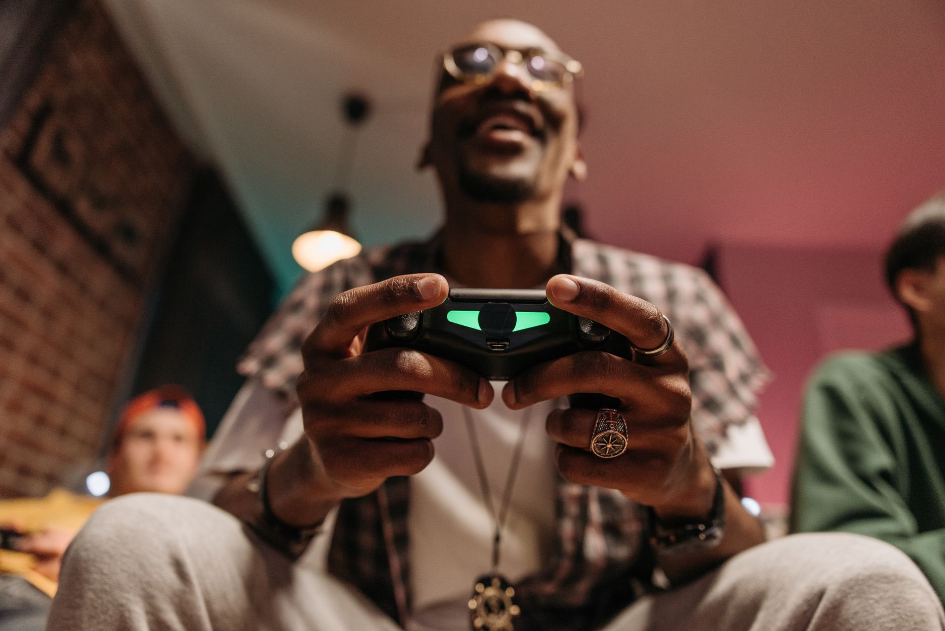 Excited man holding a controller while immersed in a video game, enjoying leisure time indoors. — Baccarat With No Minimum De